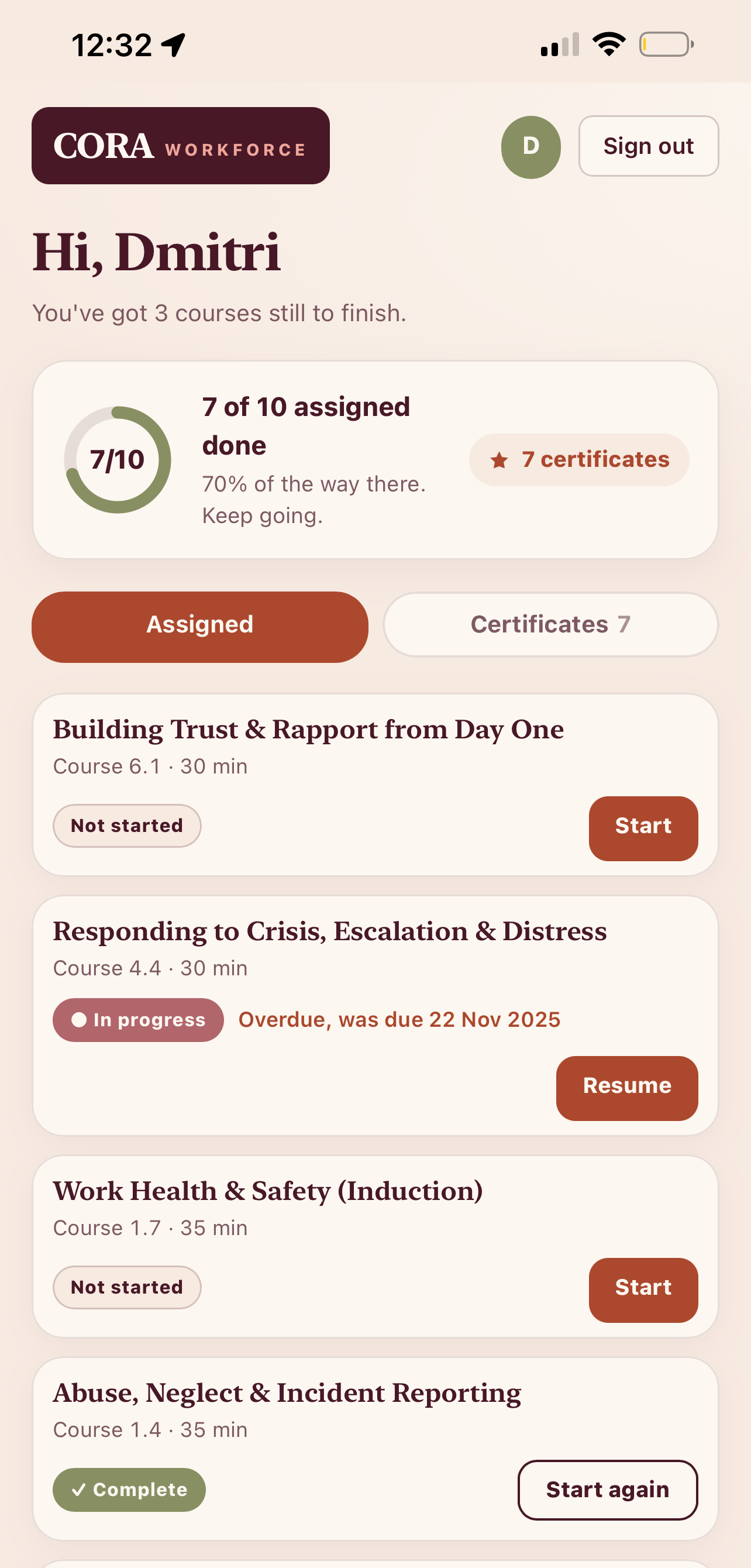 The CORA worker app on a phone: a support worker's home screen showing assigned courses, progress and certificates.
